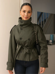 trench coat for women with a structured fit, high collar and dark buttons. Crafted from premium fabric, it highlights the waist and adds refined elegance to any autumn or winter outfit.