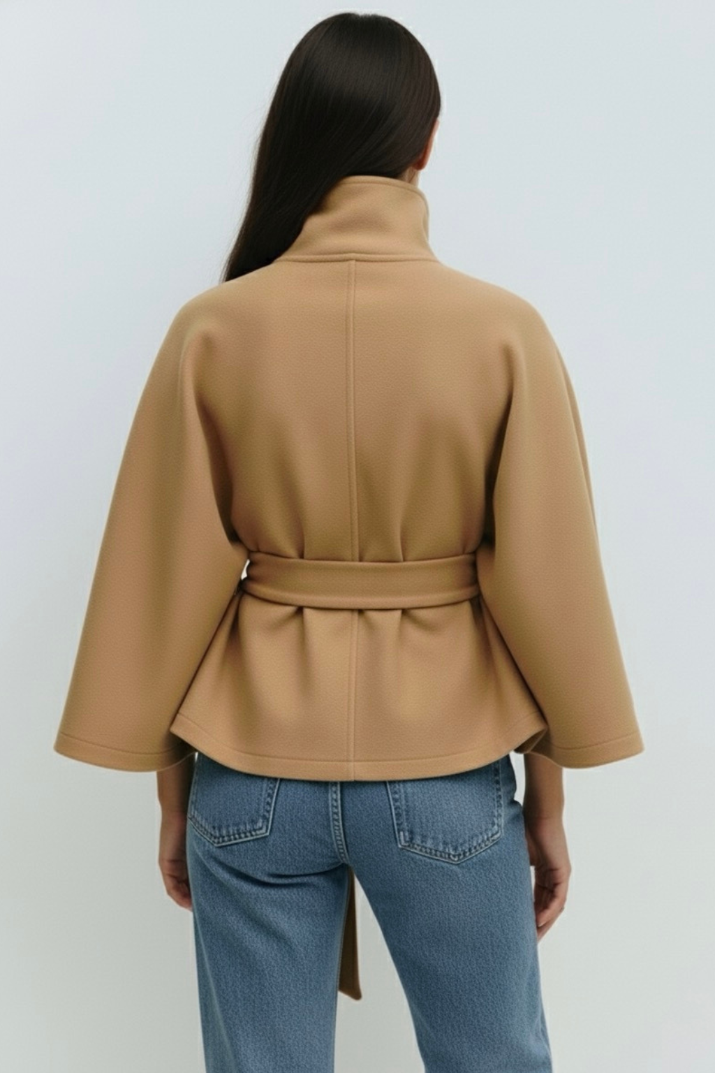 winter coat with high-neck collar, cape silhouette and adjustable waist belt. A chic belted jacket combining elegance, comfort and versatile seasonal style.
