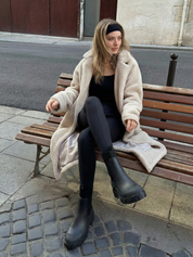 Black waterproof ankle boot with elastic side panels, pull tabs and chunky lug sole
