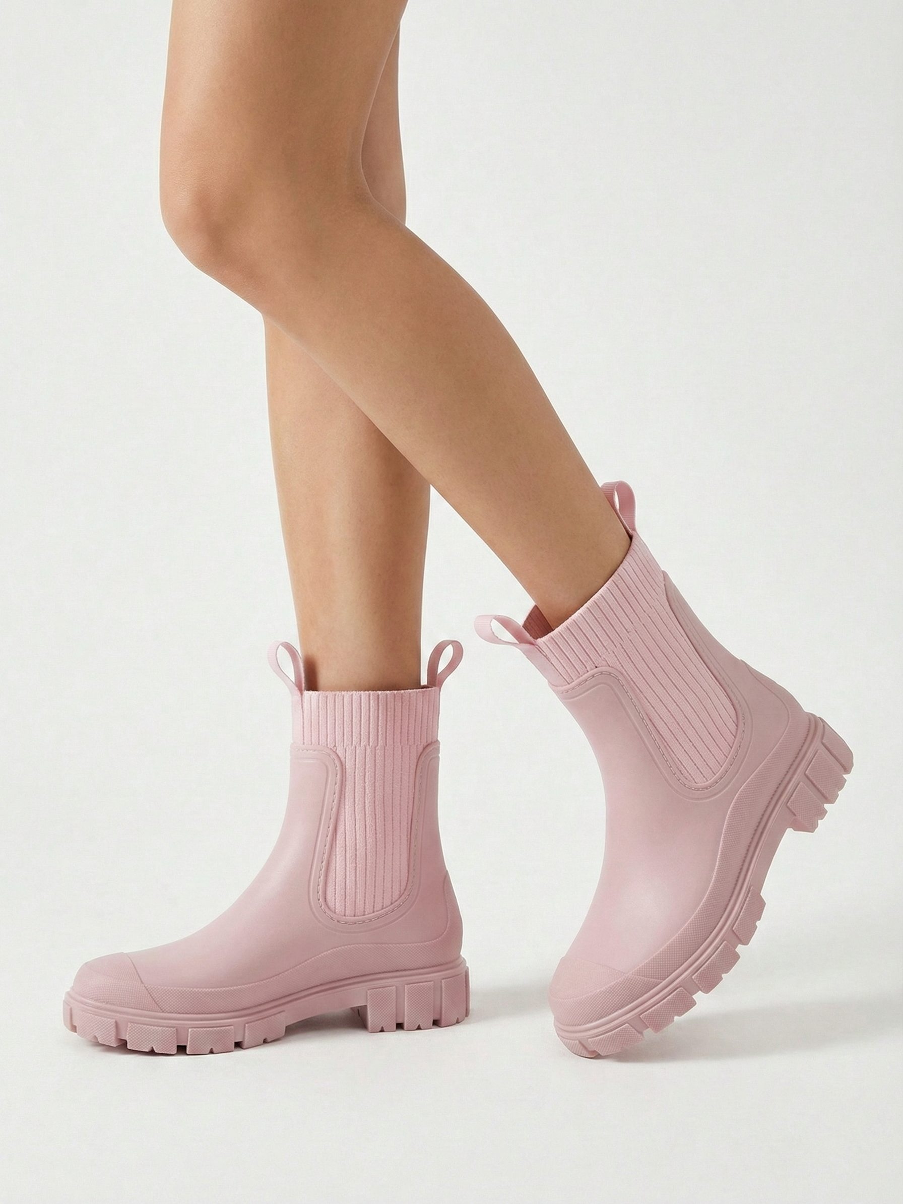 Pink waterproof ankle boot with elastic side panels, pull tabs and chunky lug sole