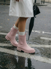 Pink waterproof ankle boot with elastic side panels, pull tabs and chunky lug sole