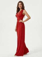 Red sleeveless jumpsuit with deep V neckline, ruched waist and wide-leg trousers