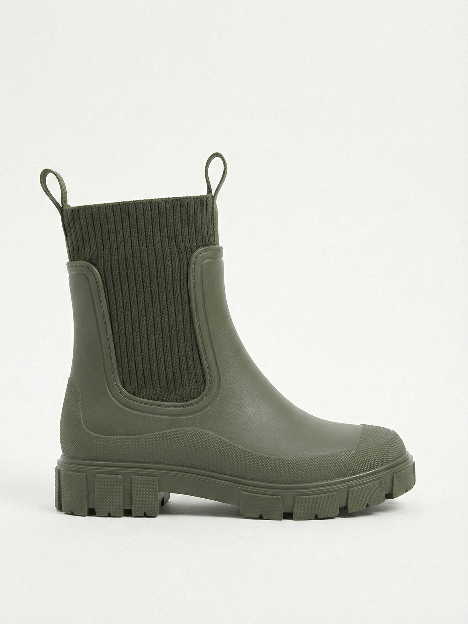 Green waterproof ankle boot with elastic side panels, pull tabs and chunky lug sole