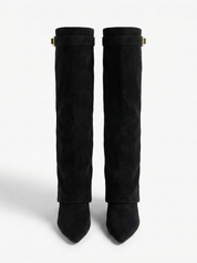 Black knee-high boot with a smooth suede-like finish, pointed toe, discreet low block heel, straight shaft design, and a slim metallic buckle detail at the top.