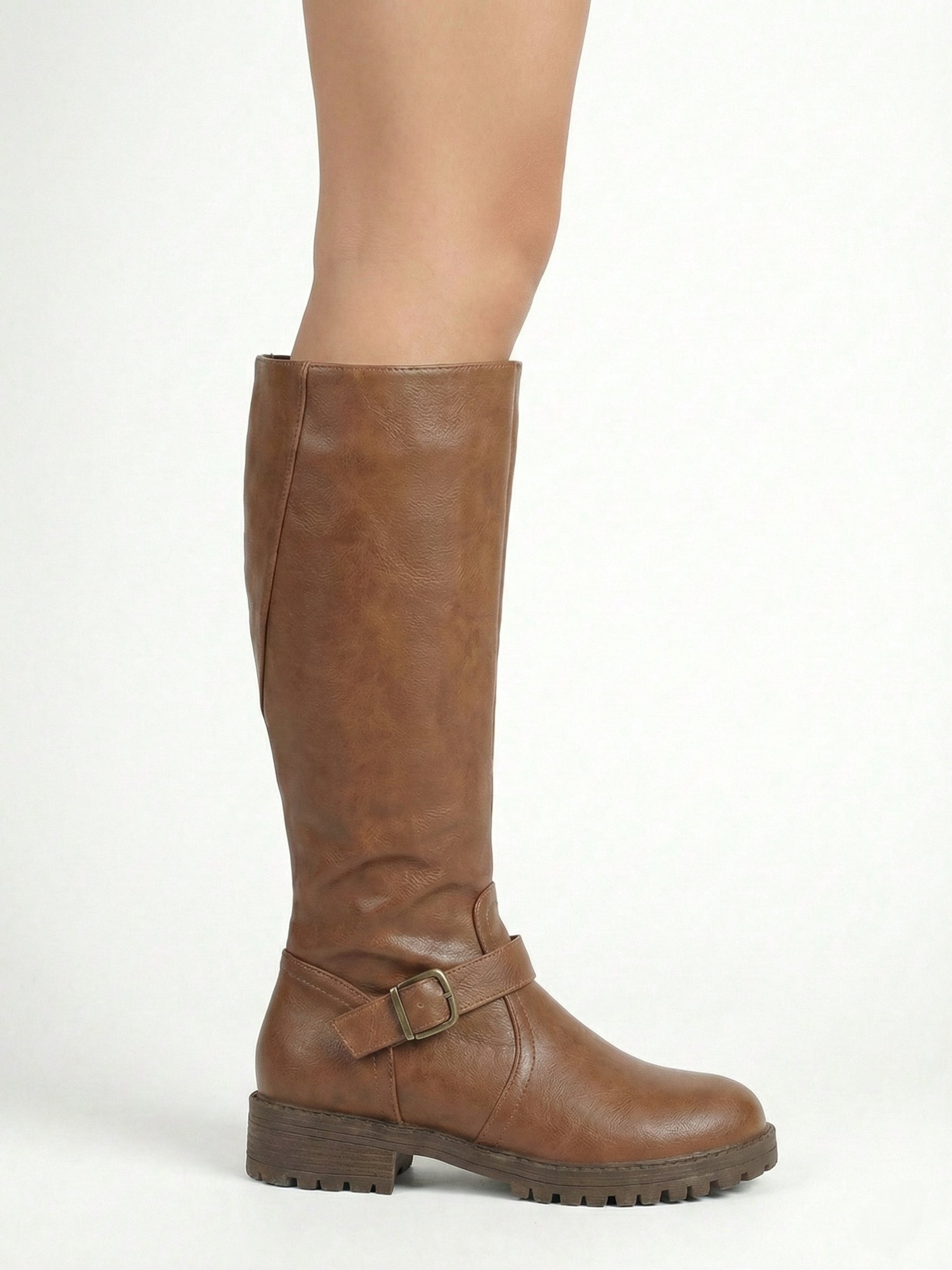 Brown knee-high leather-look boot with side buckle strap, round toe and chunky tread sole, minimalist studio white background.