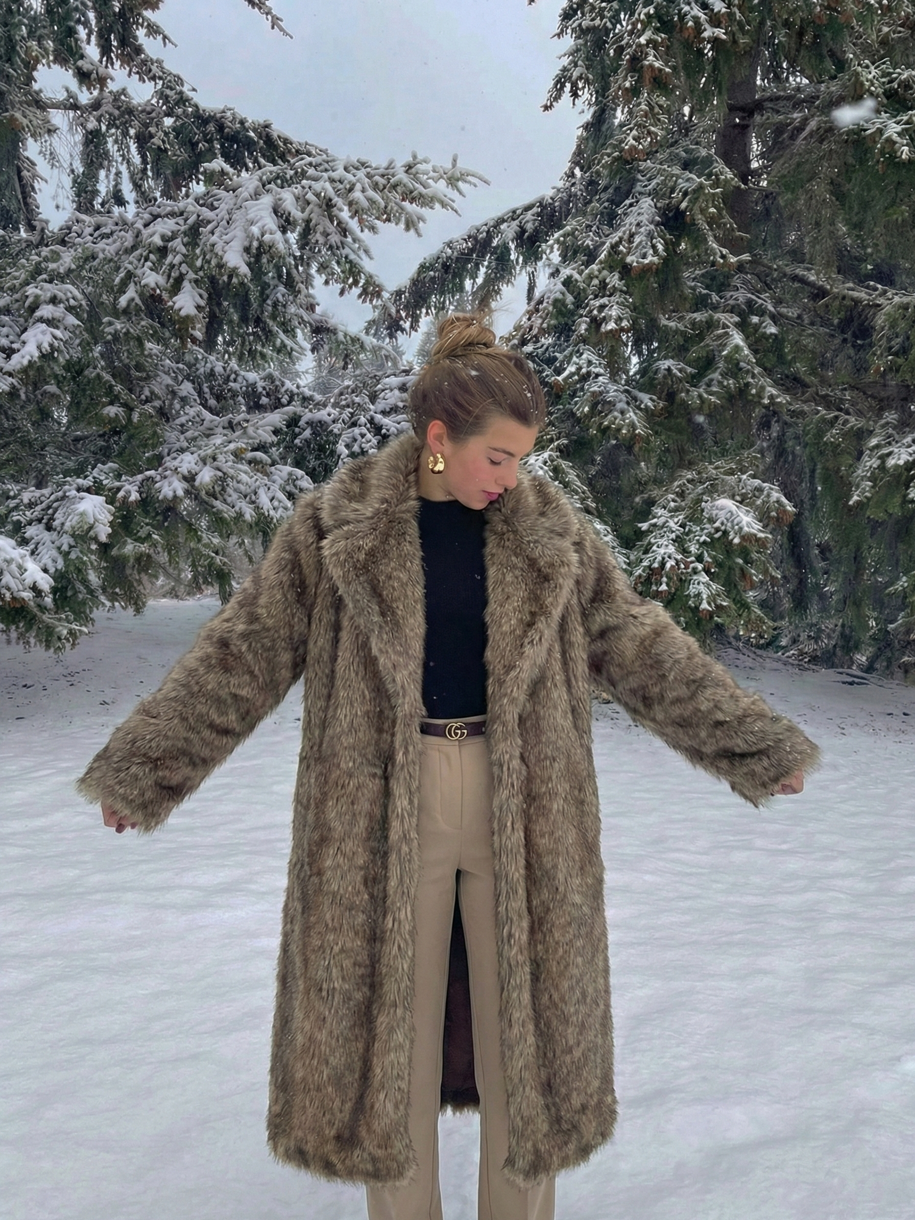 Long faux fur coat in deep brown tones with wide lapel collar and full-length silhouette