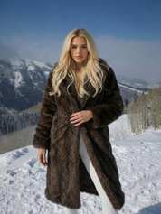 Long faux fur coat in deep brown tones with wide lapel collar and full-length silhouette