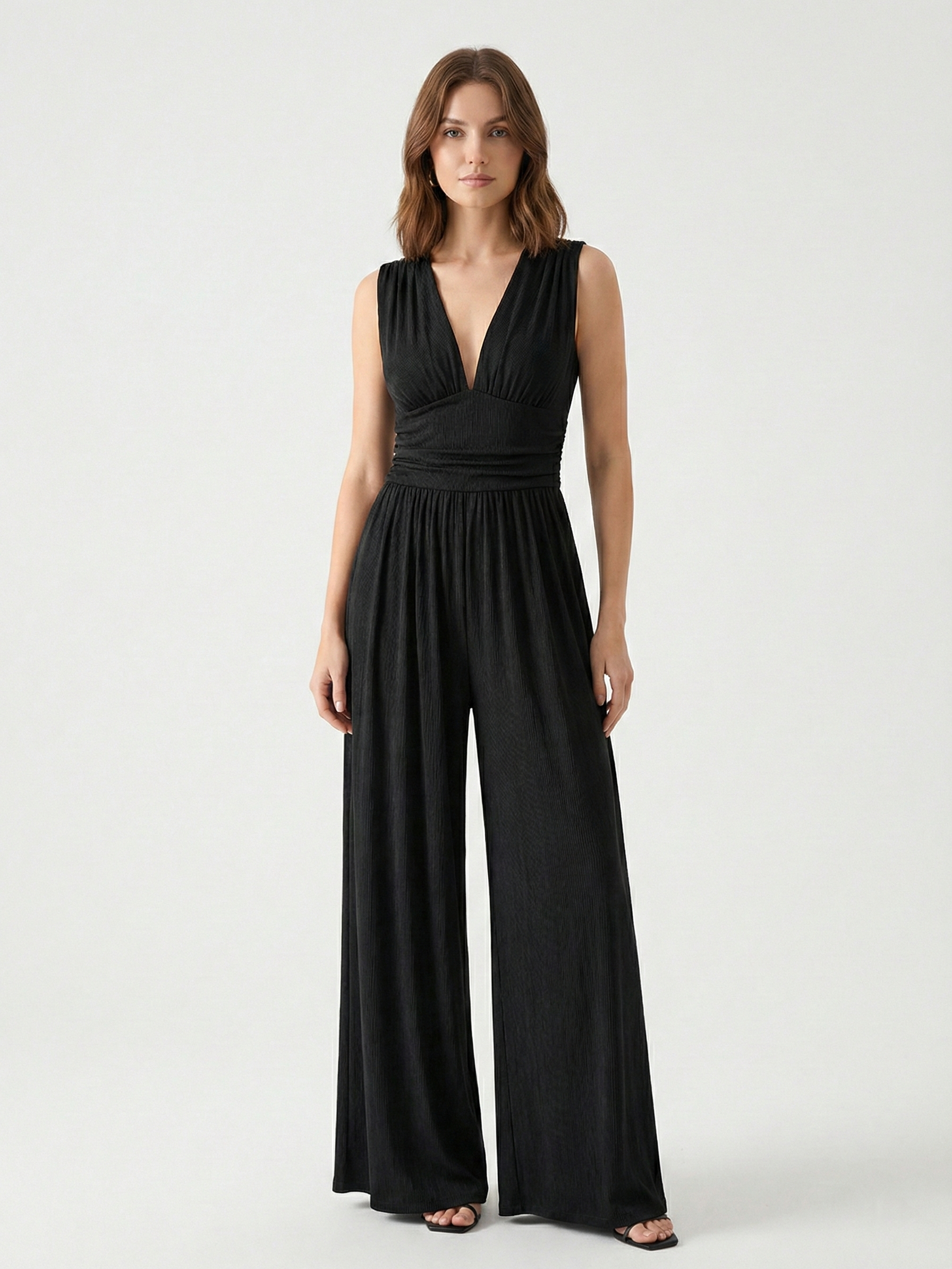 Black sleeveless jumpsuit with deep V neckline, ruched waist and wide-leg trousers