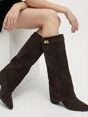 Brown knee-high boot with a smooth suede-like finish, pointed toe, discreet low block heel, straight shaft design, and a slim metallic buckle detail at the top.