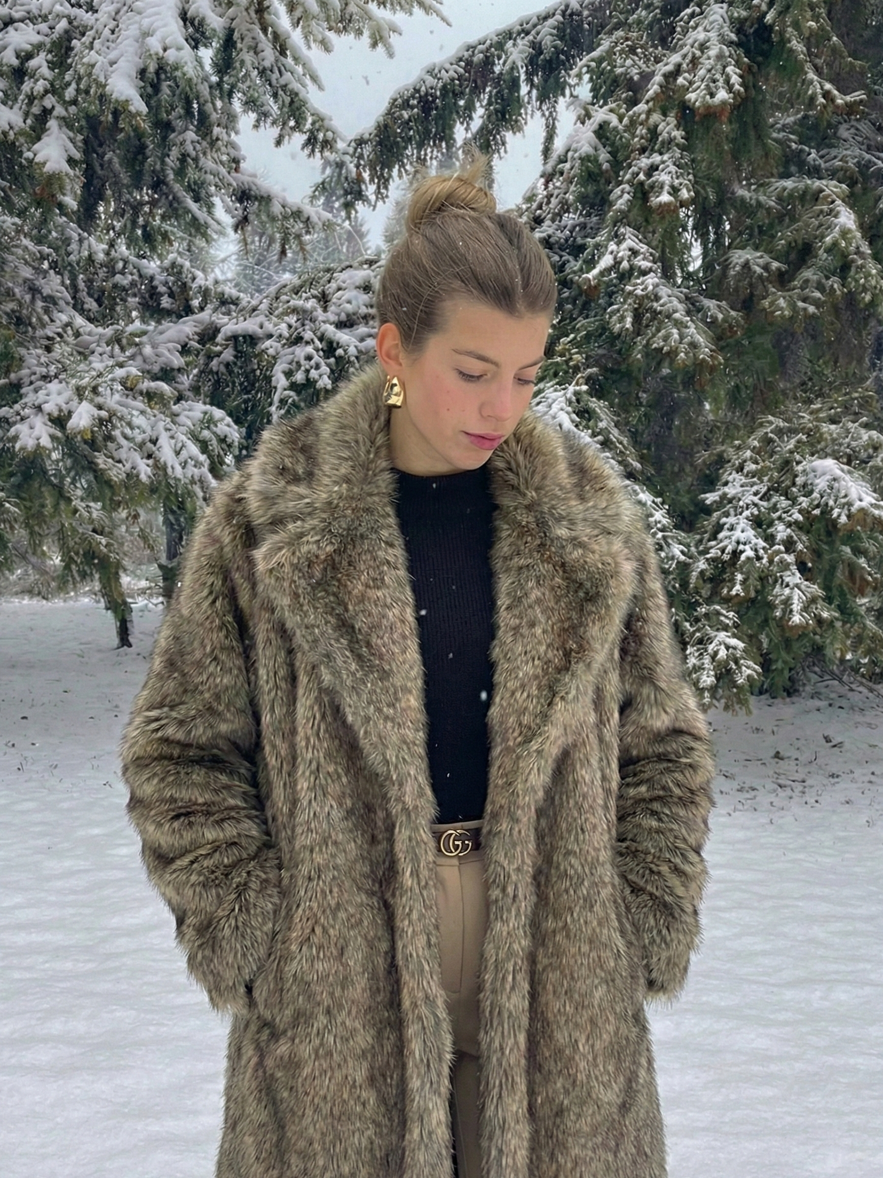 Long faux fur coat in deep brown tones with wide lapel collar and full-length silhouette