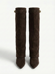 Brown knee-high boot with a smooth suede-like finish, pointed toe, discreet low block heel, straight shaft design, and a slim metallic buckle detail at the top.