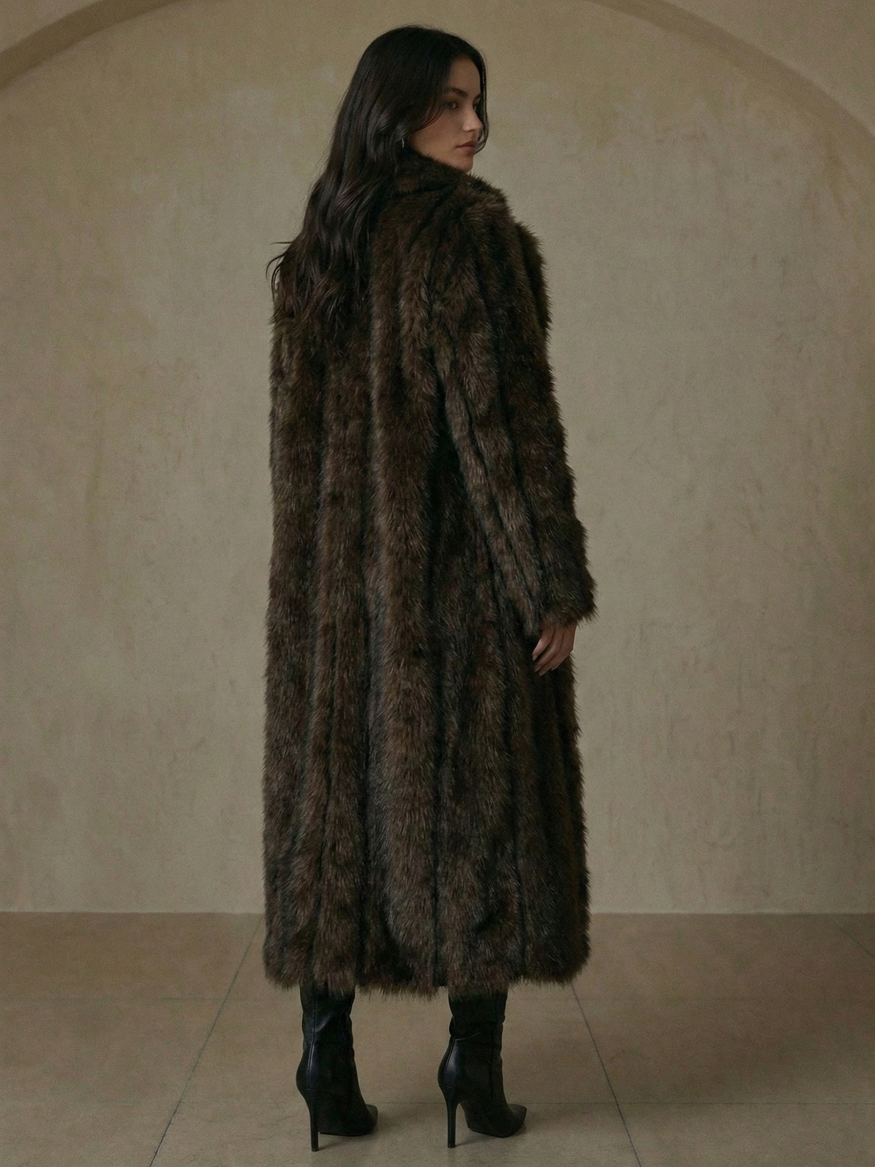 Long faux fur coat in deep brown tones with wide lapel collar and full-length silhouette