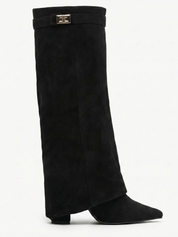 Black knee-high boot with a smooth suede-like finish, pointed toe, discreet low block heel, straight shaft design, and a slim metallic buckle detail at the top.