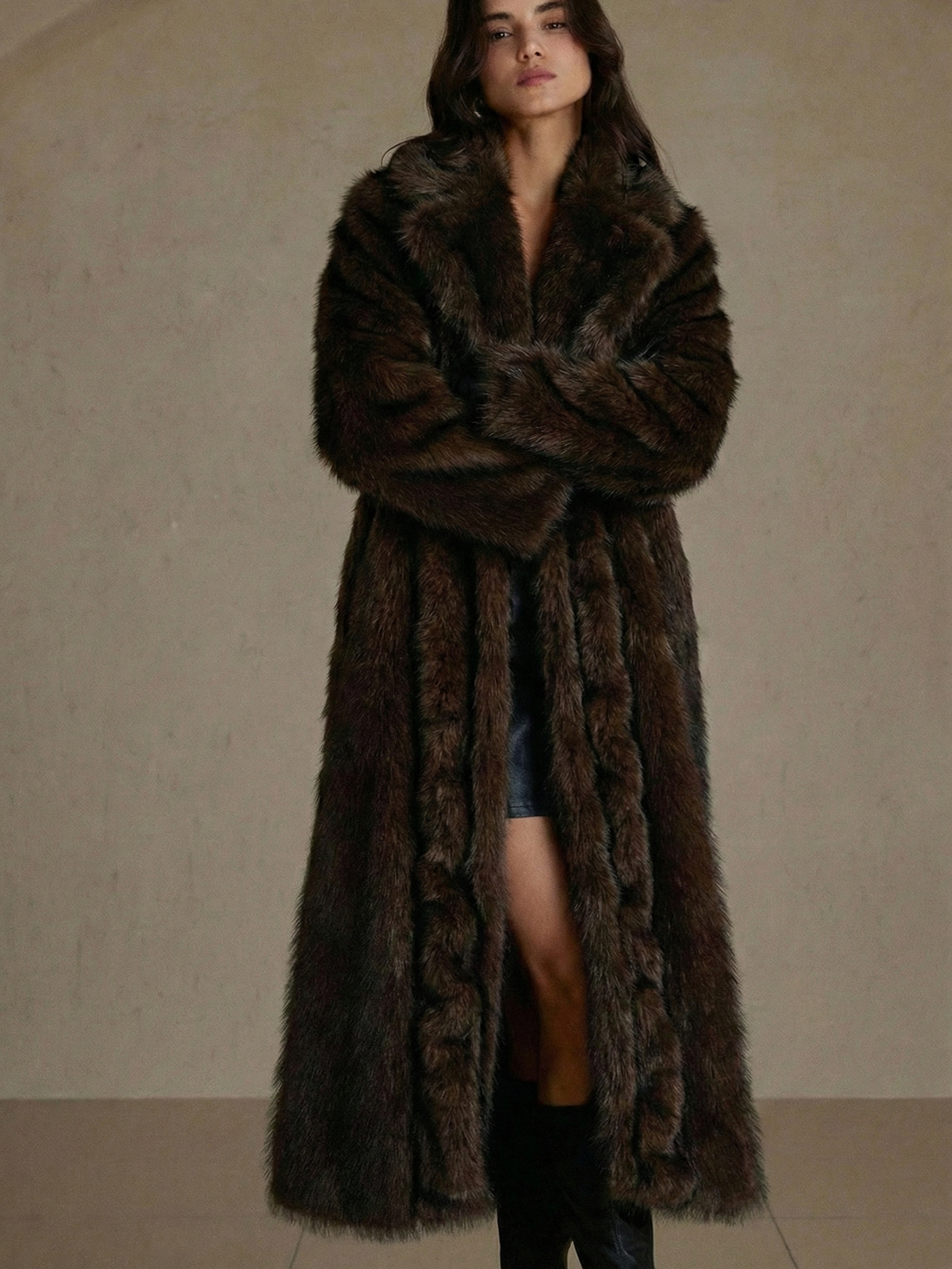 Long faux fur coat in deep brown tones with wide lapel collar and full-length silhouette