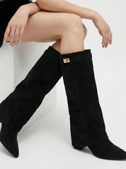 Black knee-high boot with a smooth suede-like finish, pointed toe, discreet low block heel, straight shaft design, and a slim metallic buckle detail at the top.
