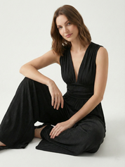 Black sleeveless jumpsuit with deep V neckline, ruched waist and wide-leg trousers
