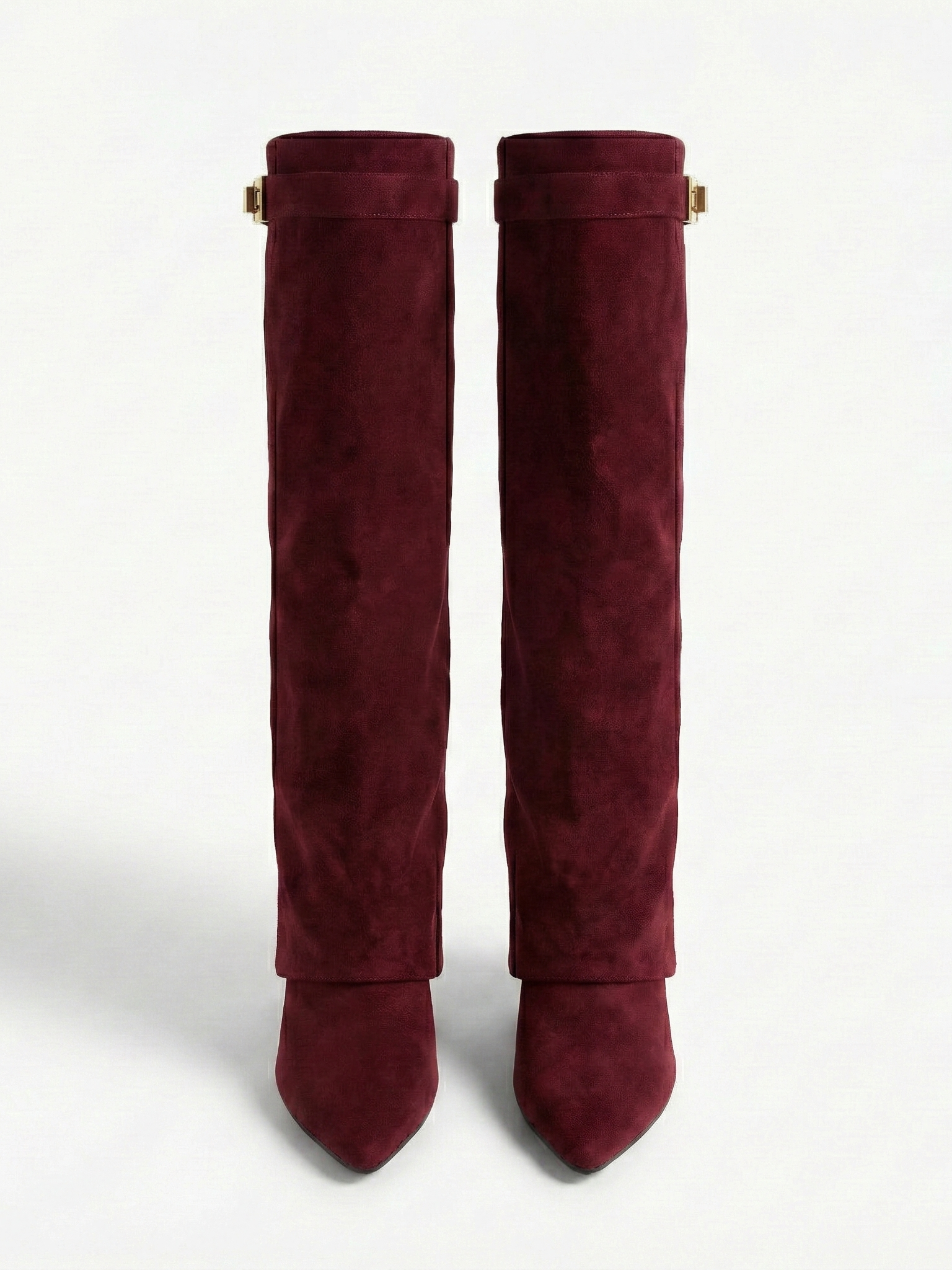 Burgundy knee-high boot with a smooth suede-like finish, pointed toe, discreet low block heel, straight shaft design, and a slim metallic buckle detail at the top.
