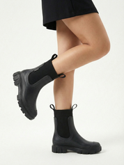 Black waterproof ankle boot with elastic side panels, pull tabs and chunky lug sole