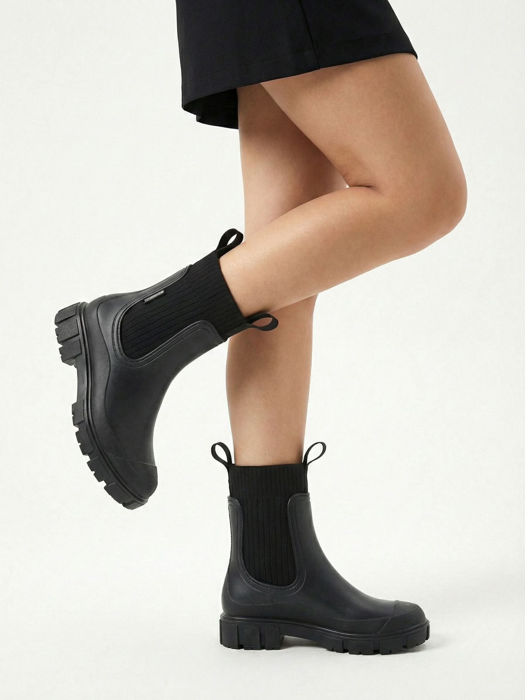 Black waterproof ankle boot with elastic side panels, pull tabs and chunky lug sole