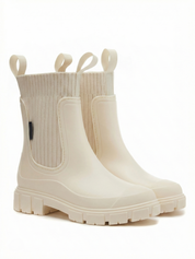 White waterproof ankle boot with elastic side panels, pull tabs and chunky lug sole