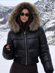 Black puffer jacket with padded quilted design and a plush faux fur hood. Features zip fastening, fitted waist and long sleeves, offering warmth and stylish winter protection.