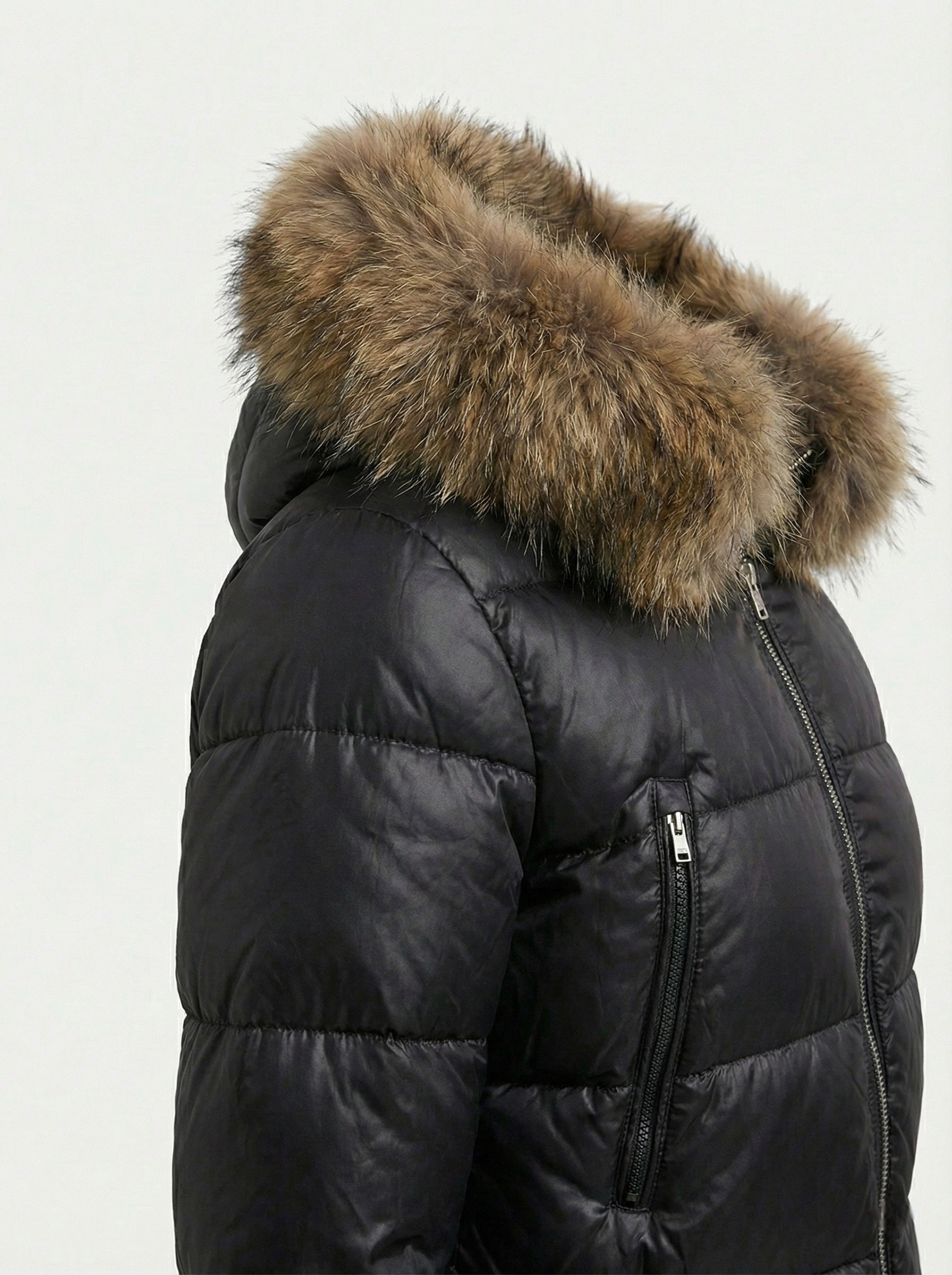 Black puffer jacket with padded quilted design and a plush faux fur hood. Features zip fastening, fitted waist and long sleeves, offering warmth and stylish winter protection.