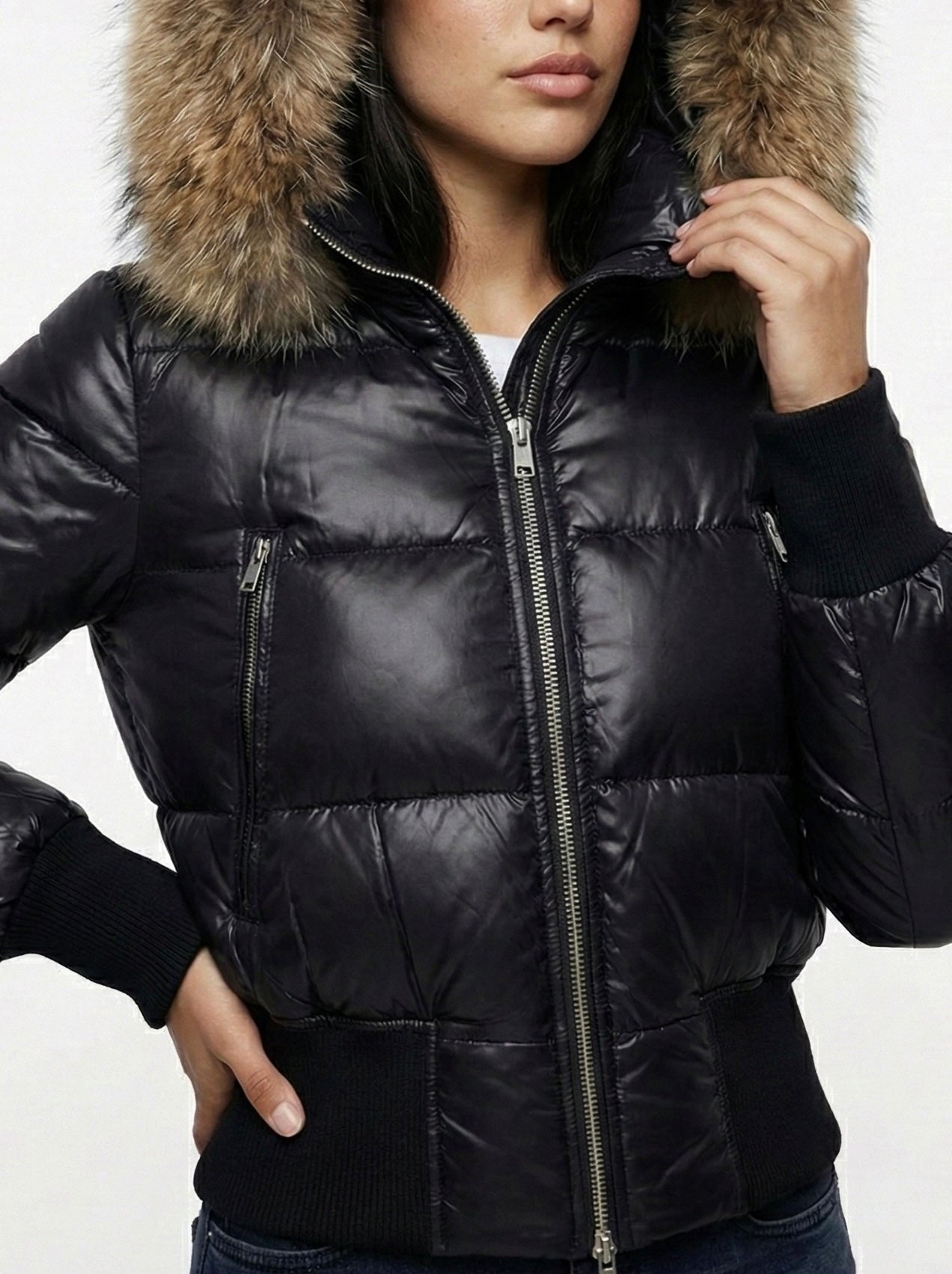 Black puffer jacket with padded quilted design and a plush faux fur hood. Features zip fastening, fitted waist and long sleeves, offering warmth and stylish winter protection.