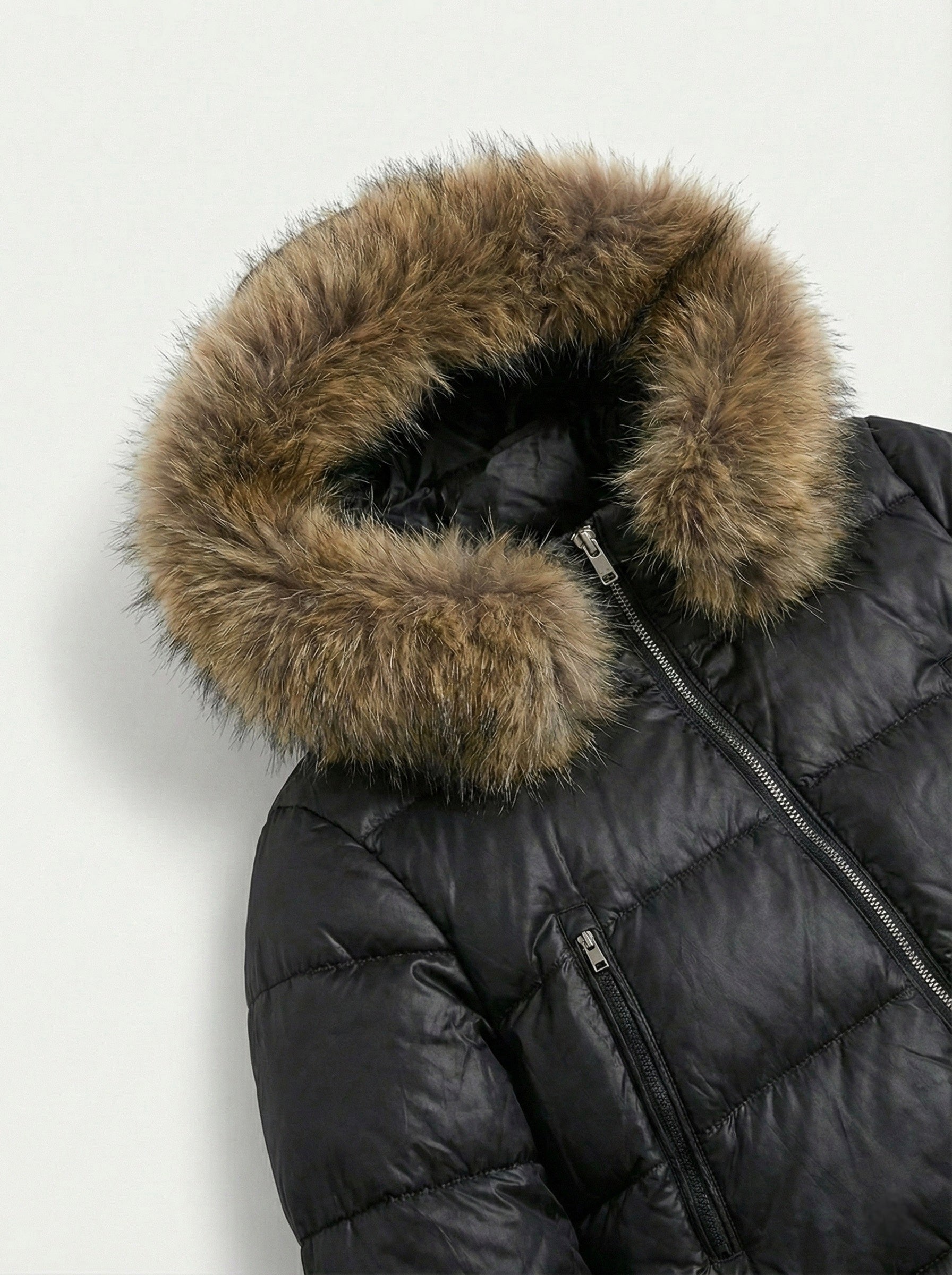 Black puffer jacket with padded quilted design and a plush faux fur hood. Features zip fastening, fitted waist and long sleeves, offering warmth and stylish winter protection.