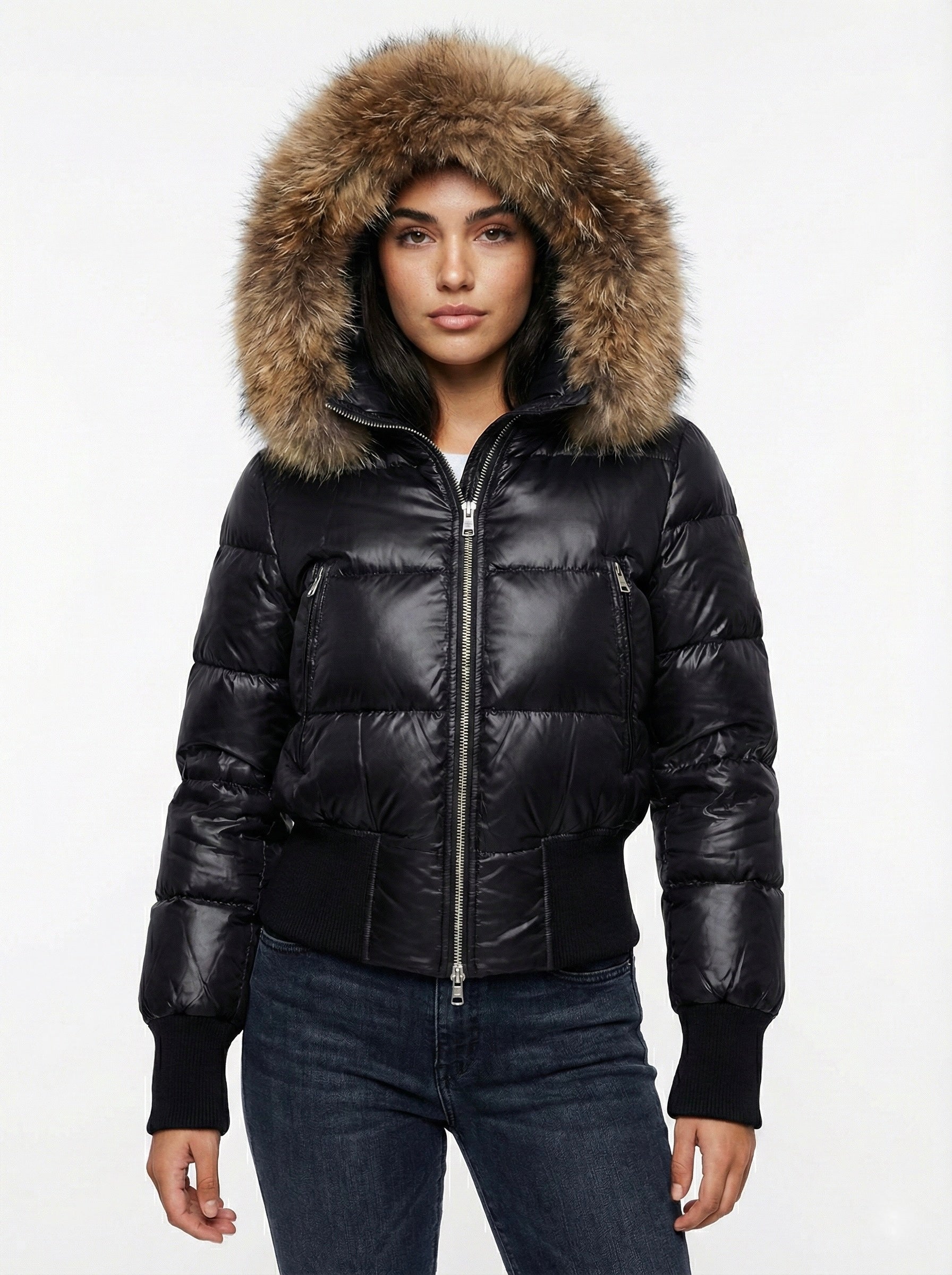 Black puffer jacket with padded quilted design and a plush faux fur hood. Features zip fastening, fitted waist and long sleeves, offering warmth and stylish winter protection.